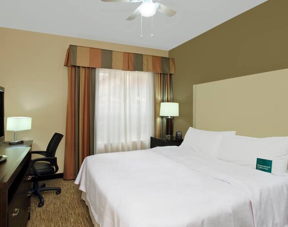 comfortable king delux room full furnished with TV and work desk at Homewood Suites by Hilton Houston-Woodlands.
