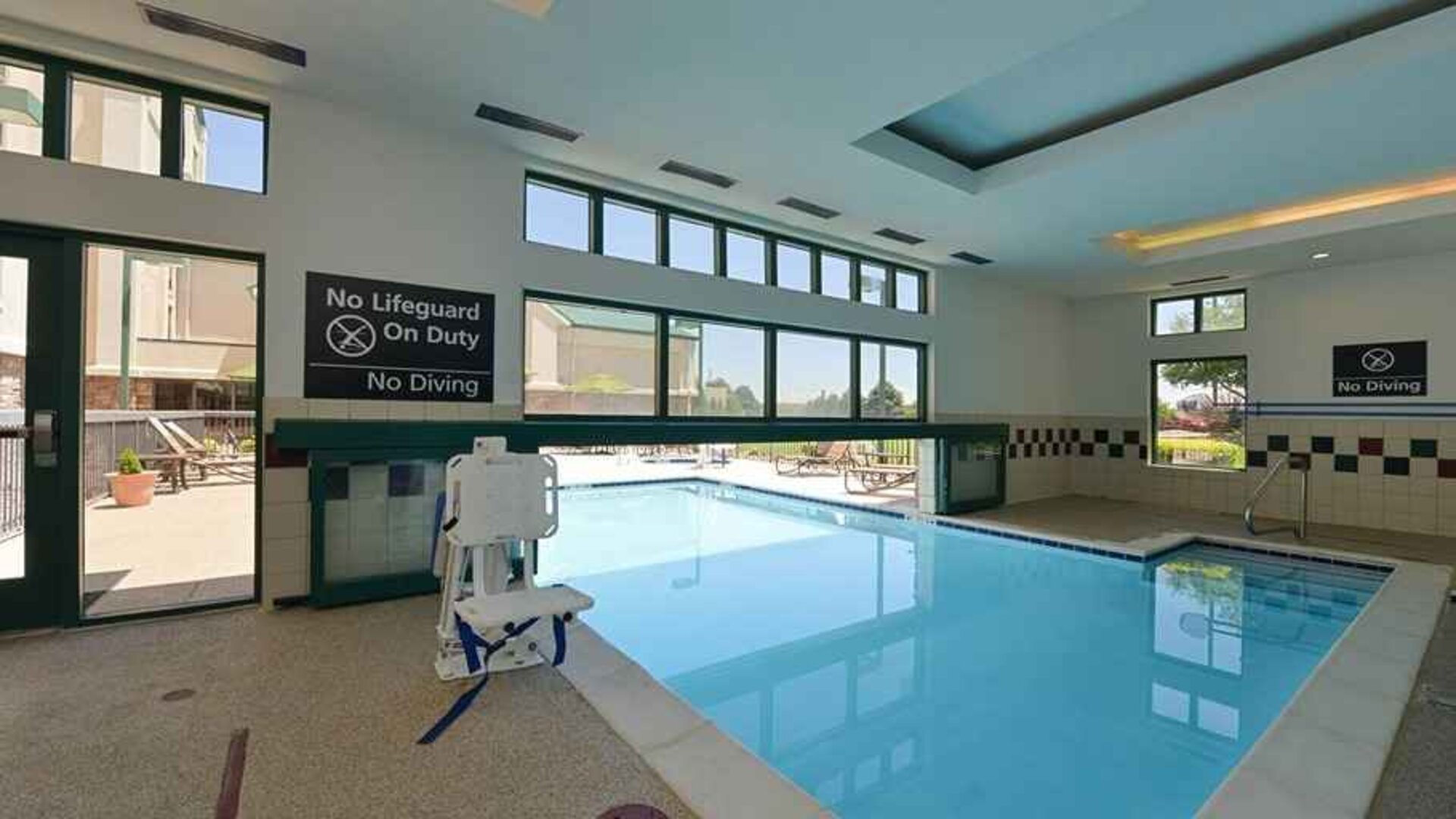 Indoor pool with seating and accessible to otherwise-abled guests at Hampton Inn & Suites Pueblo-Southgate.