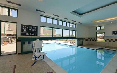 Indoor pool with seating and accessible to otherwise-abled guests at Hampton Inn & Suites Pueblo-Southgate.