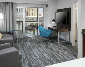 Living room with working station in a hotel suite at the Hampton Inn & Suites Memphis-Beale Street.