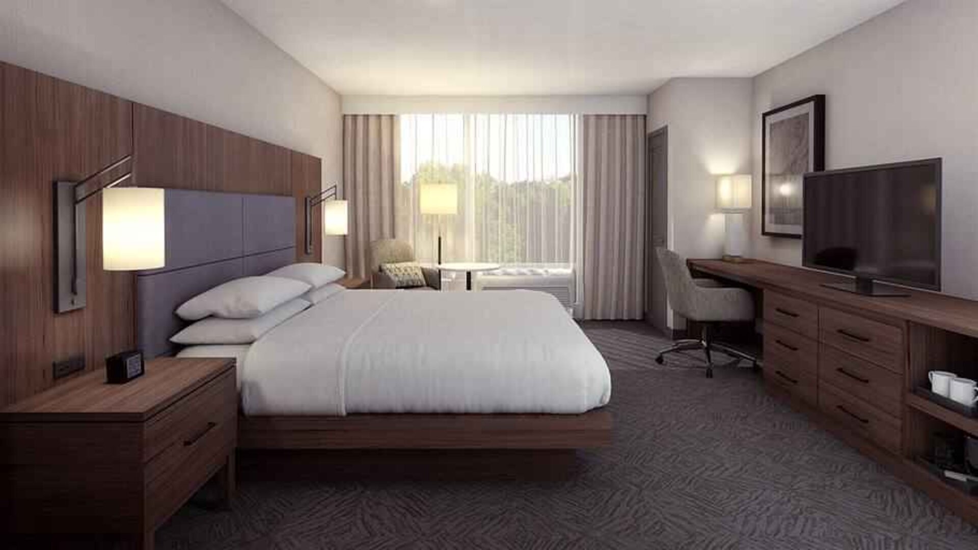 Spacious king bedroom with king size bed and sofa at the DoubleTree by Hilton Lafayette East.