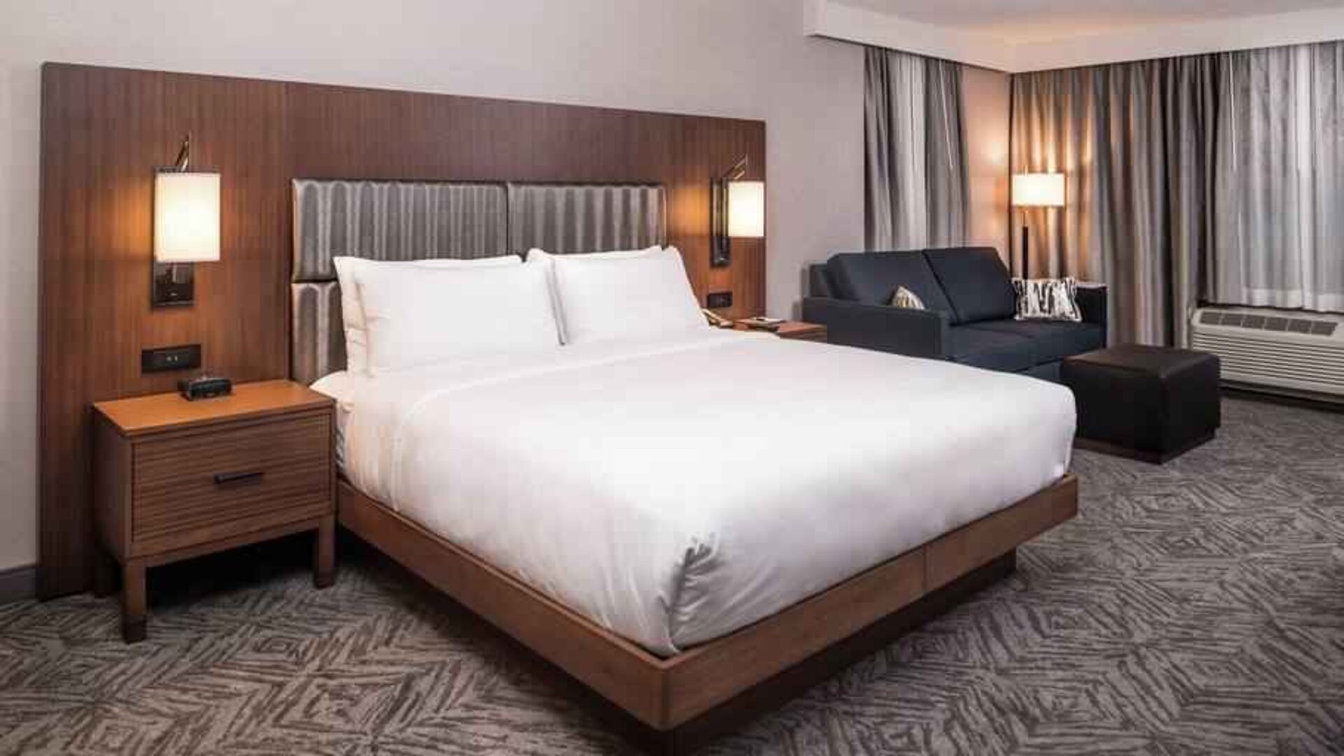 Spacious king bedroom with king size bed and sofa at the DoubleTree by Hilton Lafayette East.