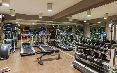 Well-equipped fitness center at The Sam Houston, Curio Collection by Hilton.