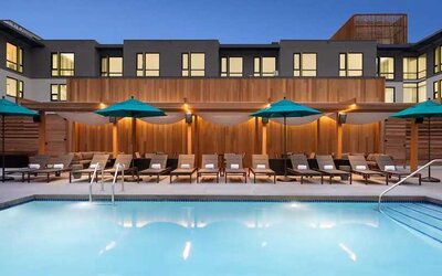 gorgeous outdoor pool with sun beds and seating area at Embassy Suites by Hilton Boulder.