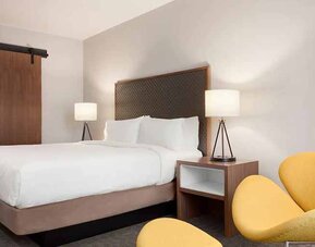 beautiful king room with lounge area at Hilton Garden Inn Boulder.