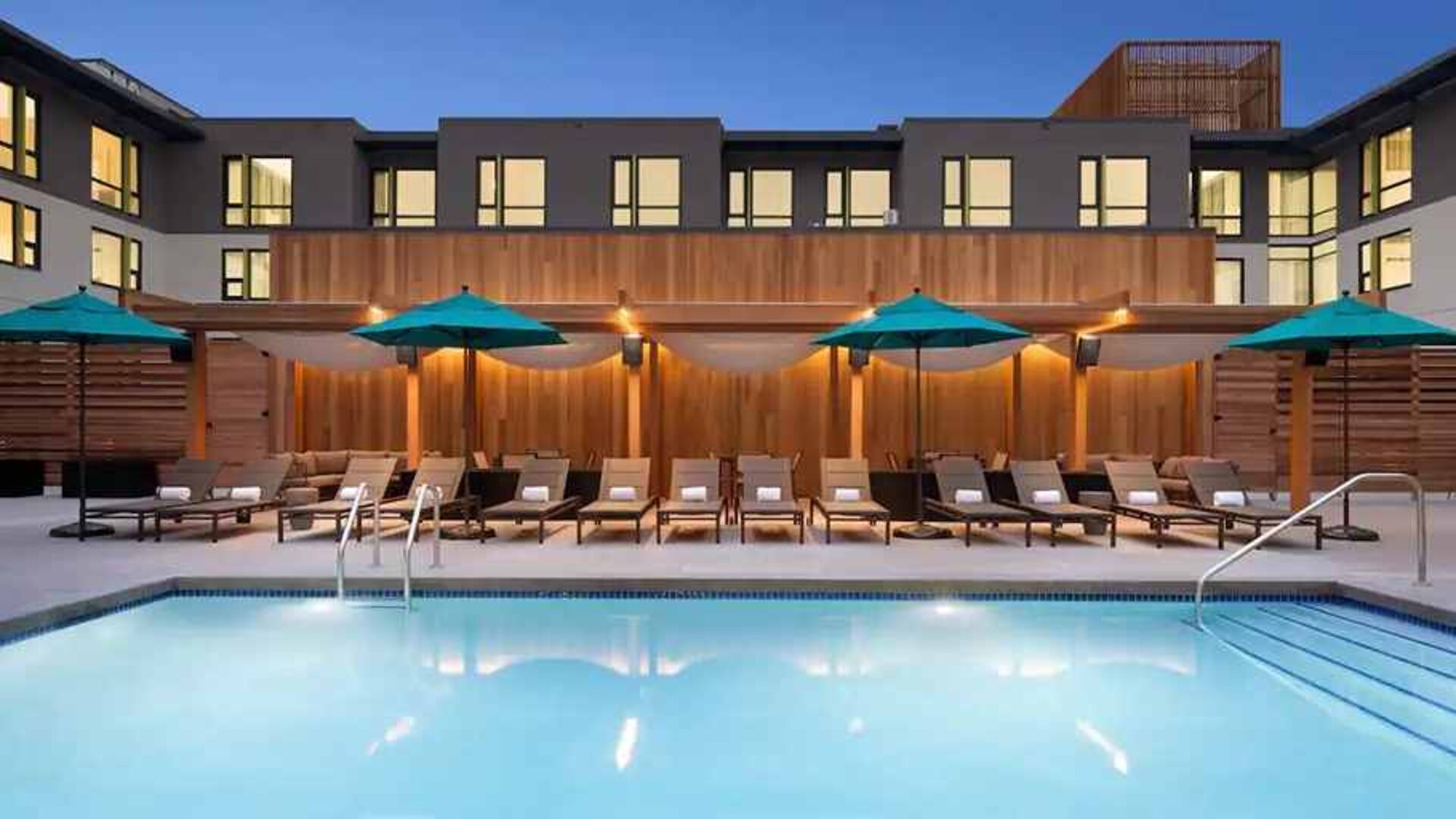 beautiful outdoor pool with sunbeds and seating area at Hilton Garden Inn Boulder.