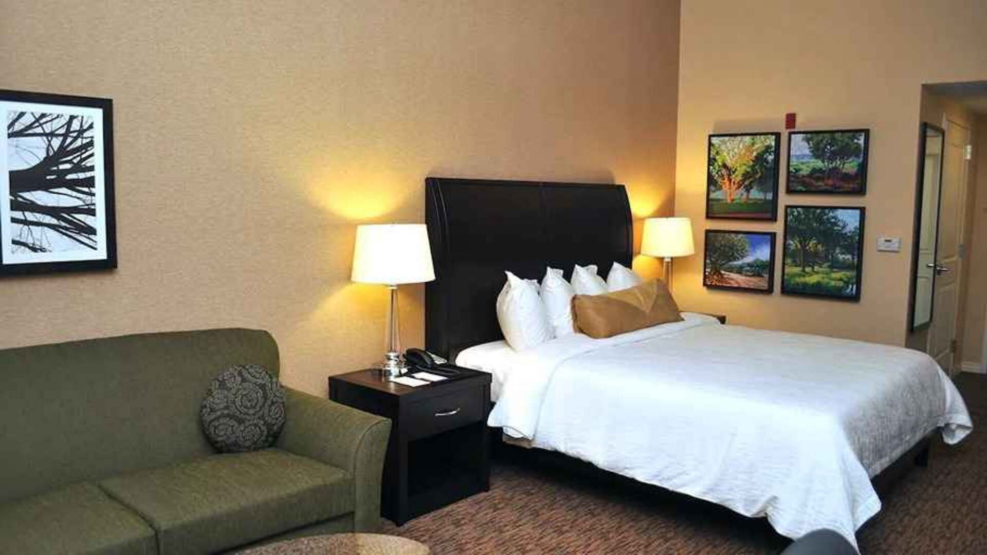comfortable delux king room with lounge area at Hilton Garden Inn St. Louis Airport.
