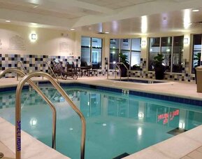 relaxing indoor pool with comfortable seating at Hilton Garden Inn St. Louis Airport.