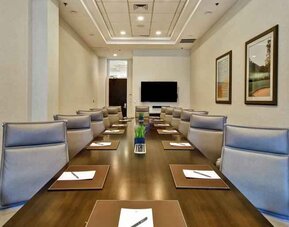 Elegant meeting room with comfortable chairs at the Embassy Suites by Hilton Greenville Golf Resort Conference Center