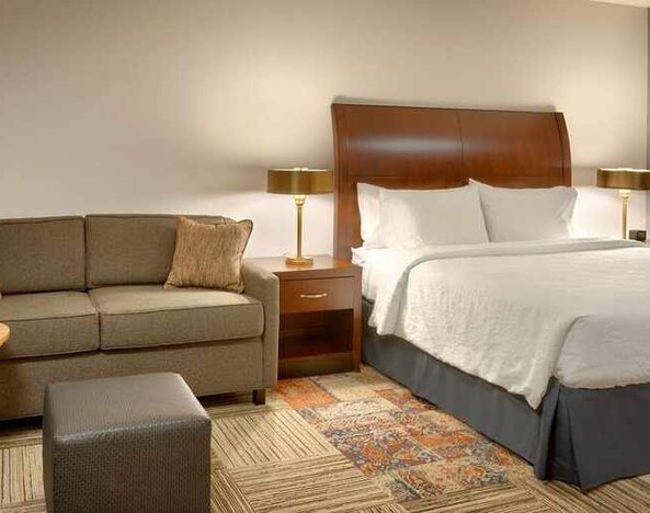 comfortable king room with lounge area at Hilton Garden Inn Salt Lake City/Sandy.