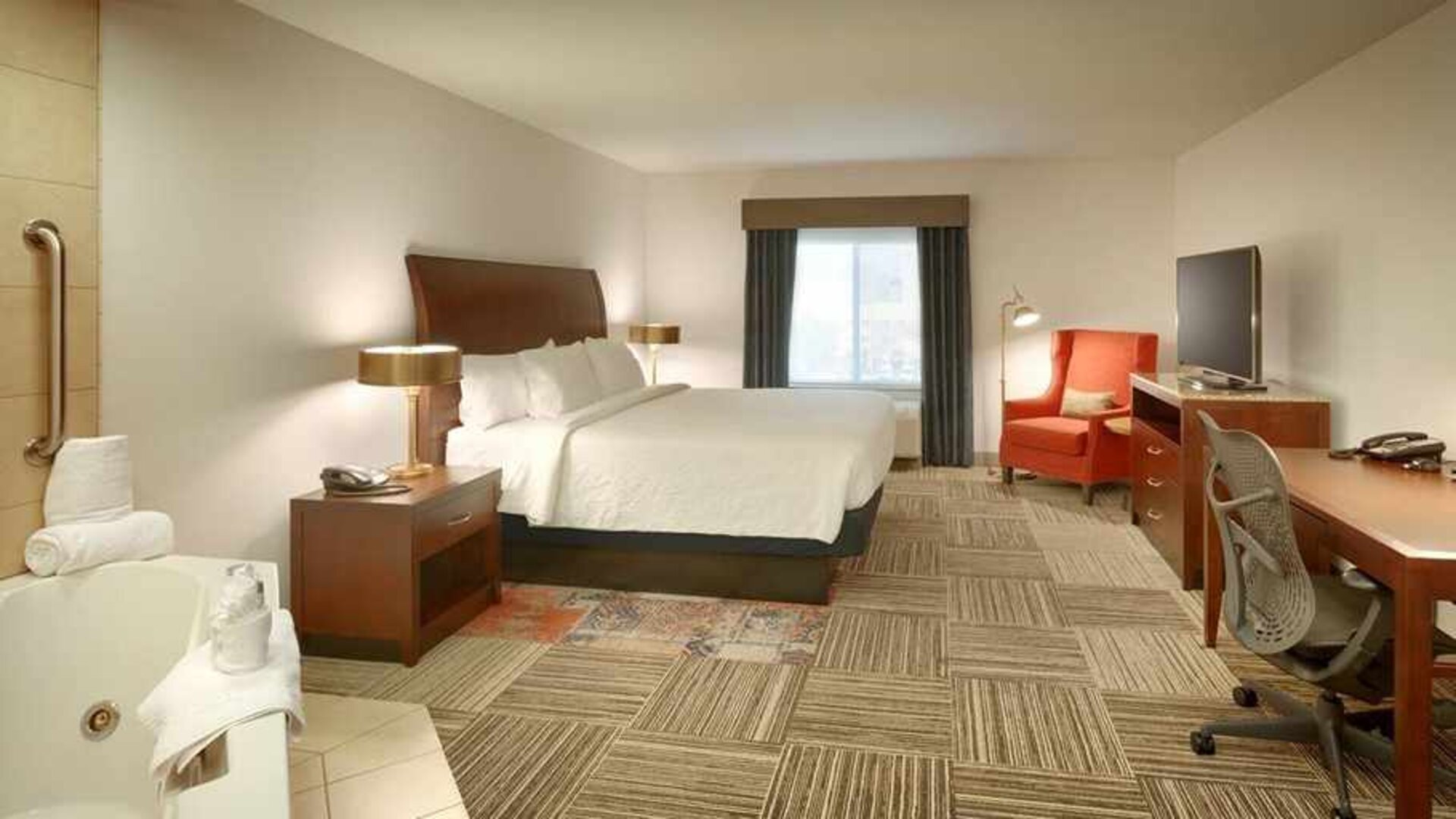 spacious delux king room with lounge area and work desk ideal for working remotely at Hilton Garden Inn Salt Lake City/Sandy.