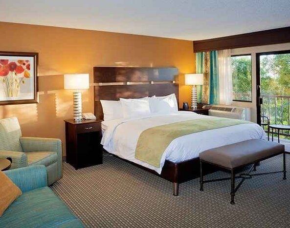 spacious king suite with balcony seating and lounge area at DoubleTree by Hilton Hotel Santa Fe.