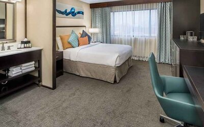 Spacious king room with work desk ideal for working remotely at Embassy Suites by Hilton Seattle Tacoma International Airport.