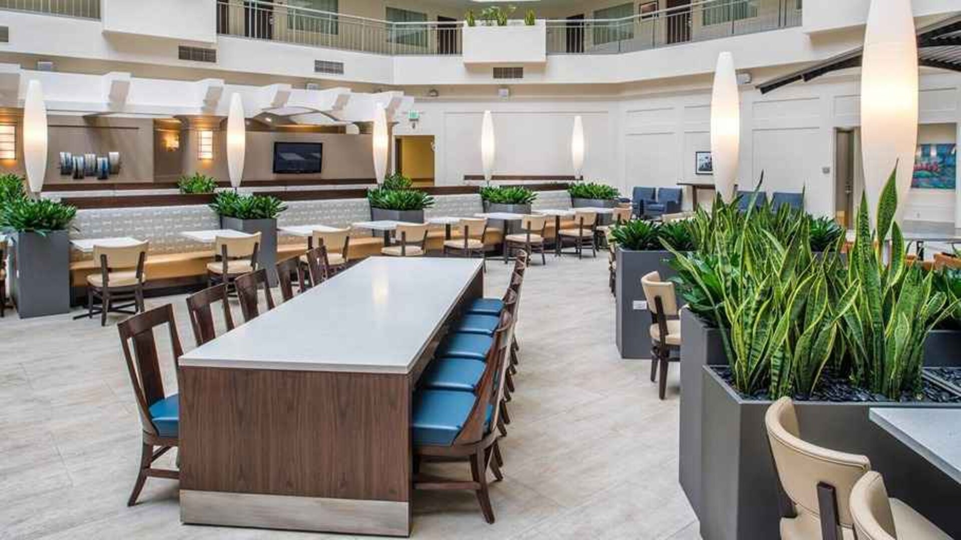 Comfortable lobby lounge area ideal as a coworking space at Embassy Suites by Hilton Seattle Tacoma International Airport.
