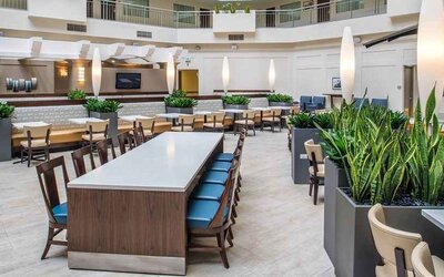 Comfortable lobby lounge area ideal as a coworking space at Embassy Suites by Hilton Seattle Tacoma International Airport.