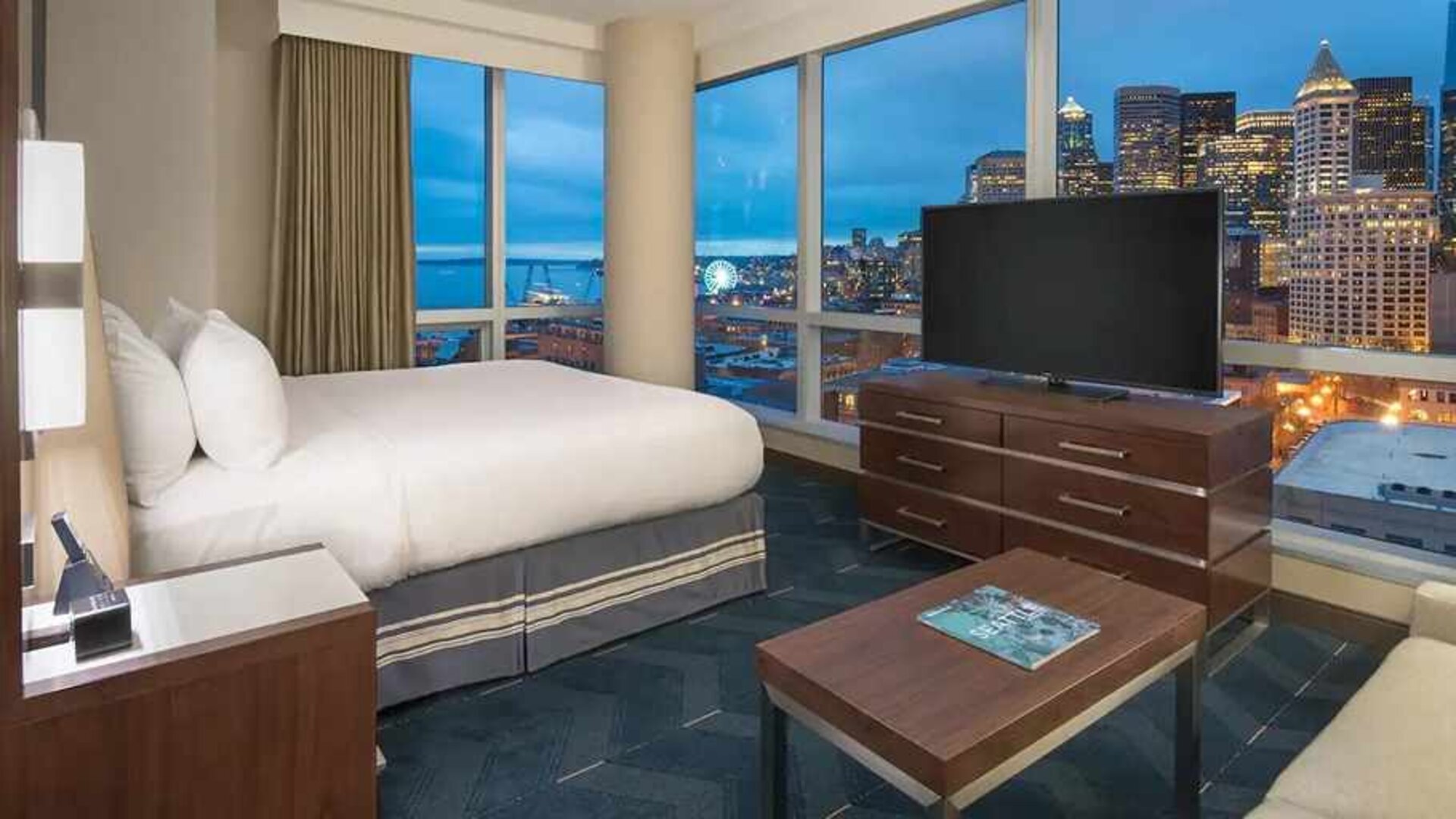 beautiful king suite with TV and city views at Embassy Suites by Hilton Seattle Downtown Pioneer Square.