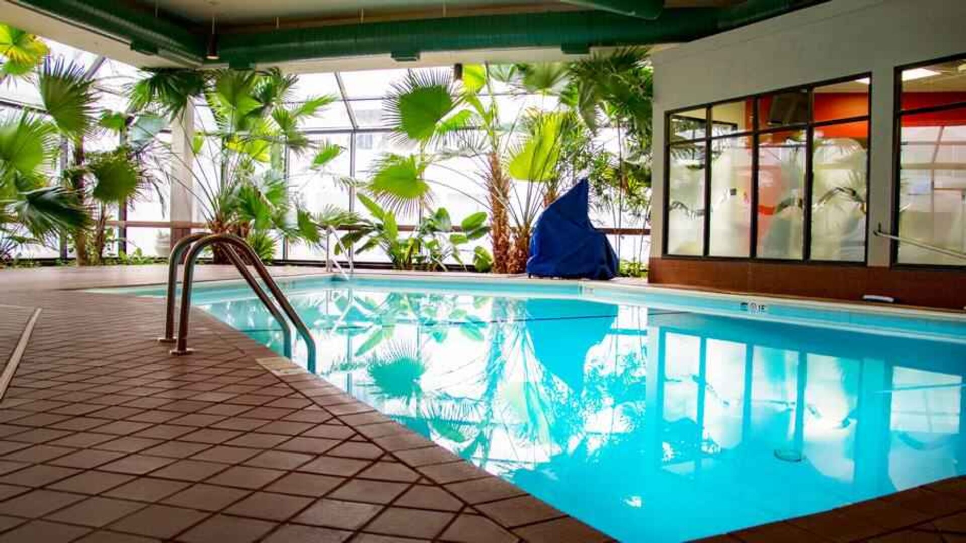 Beautiful indoor pool with plants at the DoubleTree by Hilton Wichita Airport.