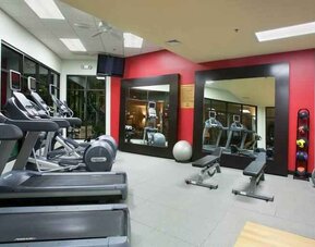Fitness center with treadmills and weights at the DoubleTree by Hilton Wichita Airport.