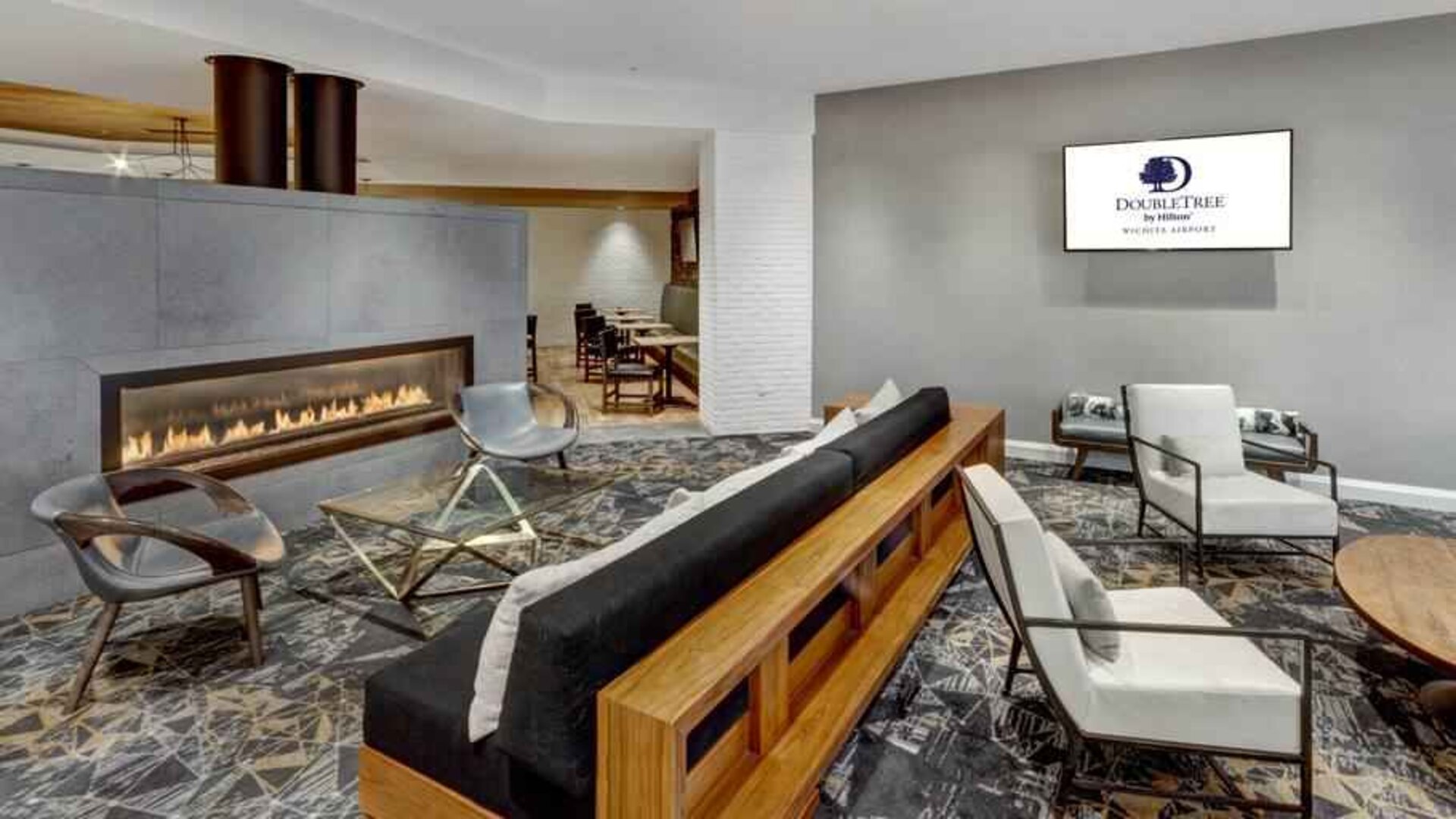 Stylish lobby workspace by the fireplace at the DoubleTree by Hilton Wichita Airport.