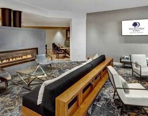 Stylish lobby workspace by the fireplace at the DoubleTree by Hilton Wichita Airport.
