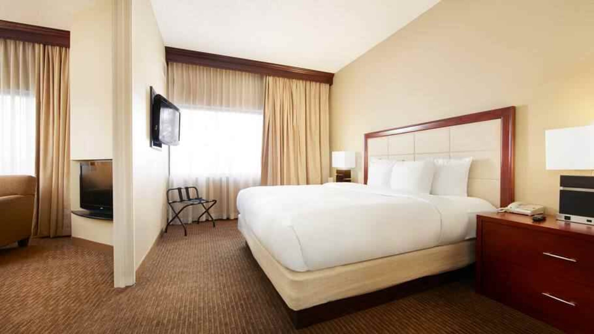 King bedroom with window at the DoubleTree Suites by Hilton Cincinnati-Blue Ash.