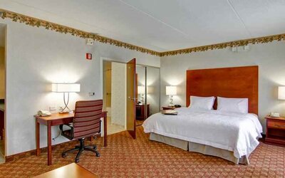 King bedroom with desk at the Hampton Inn & Suites Leesburg.