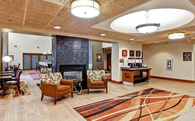 Comfortable lobby workspace by the fireplace at the Hampton Inn & Suites Leesburg.