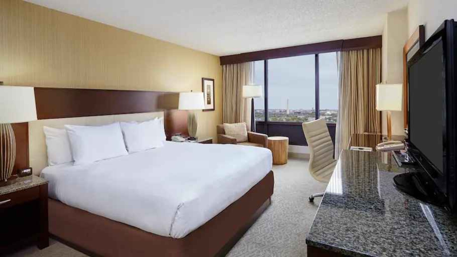 Comfortable king size bed in a hotel guestroom at the DoubleTree by Hilton Washington DC - Crystal City.