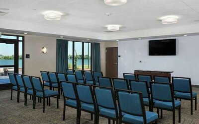 Meeting room with tables and screen at the Hampton Inn Burley.