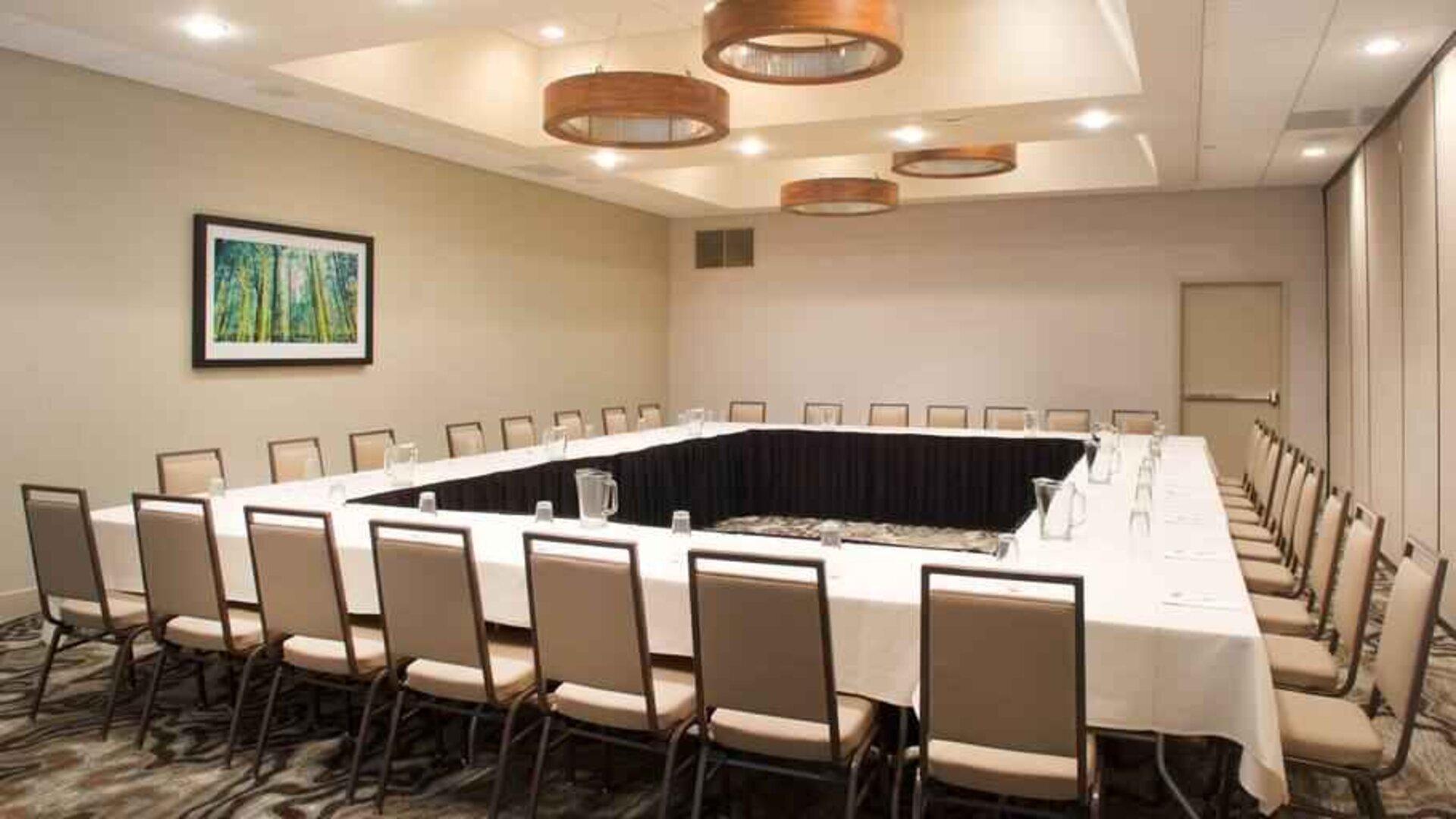 Meeting room with square conference table at the Embassy Suites by Hilton Cincinnati Blue Ash.