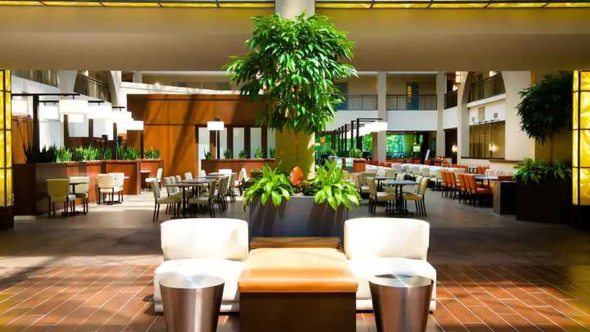 Elegant lobby workspace with plants at the Embassy Suites by Hilton Cincinnati Blue Ash.