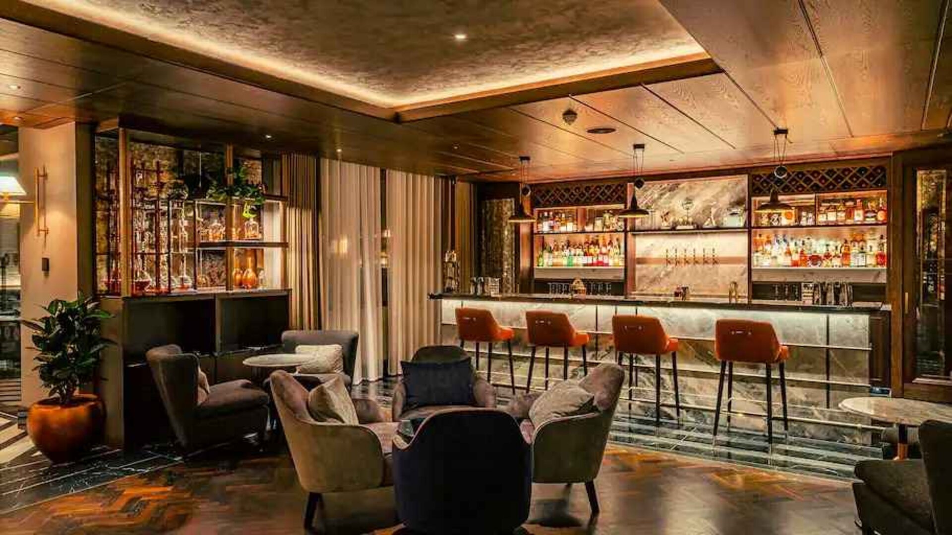 Co-working space along the bar area at the Fellows House Cambridge, Curio Collection by Hilton.