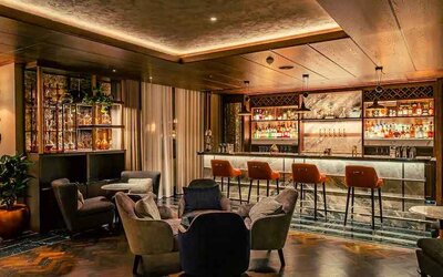 Co-working space along the bar area at the Fellows House Cambridge, Curio Collection by Hilton.