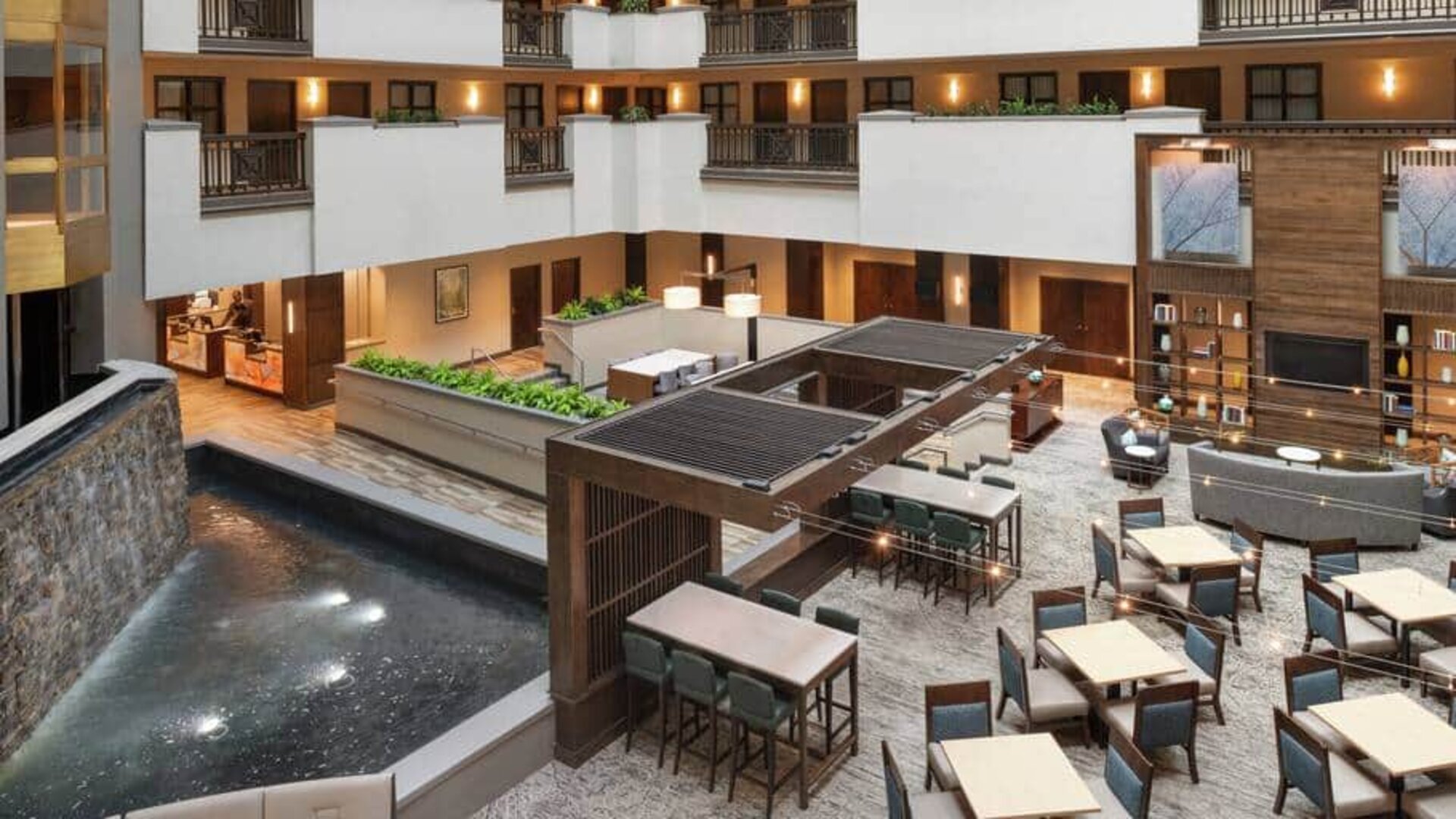 Overhead zoomed out view of common lobby area in center of hotel, a place to meet, eat, work.