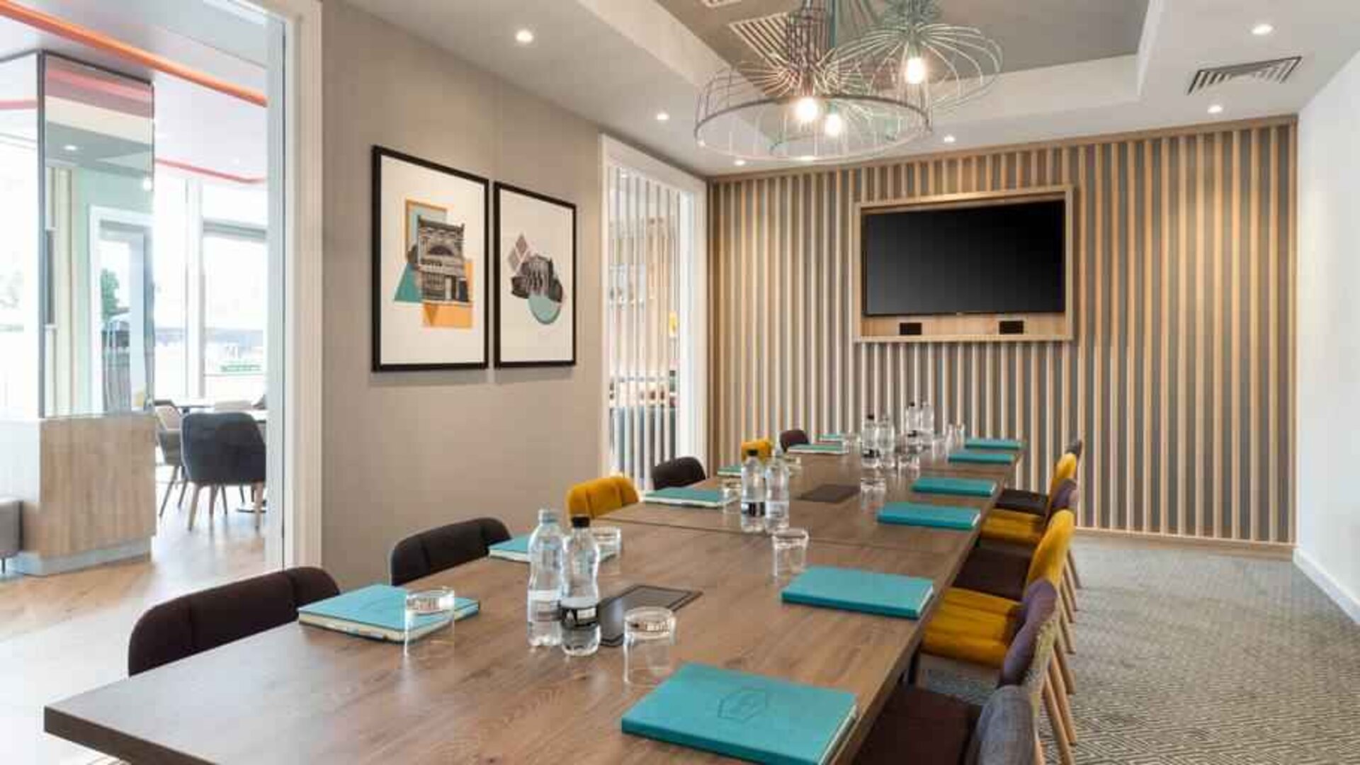 Small meeting room with TV screen at the Hampton by Hilton London Ealing.