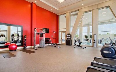 Well equipped fitness center with natural light at Homewood Suites by Hilton University City Philadelphia, PA.