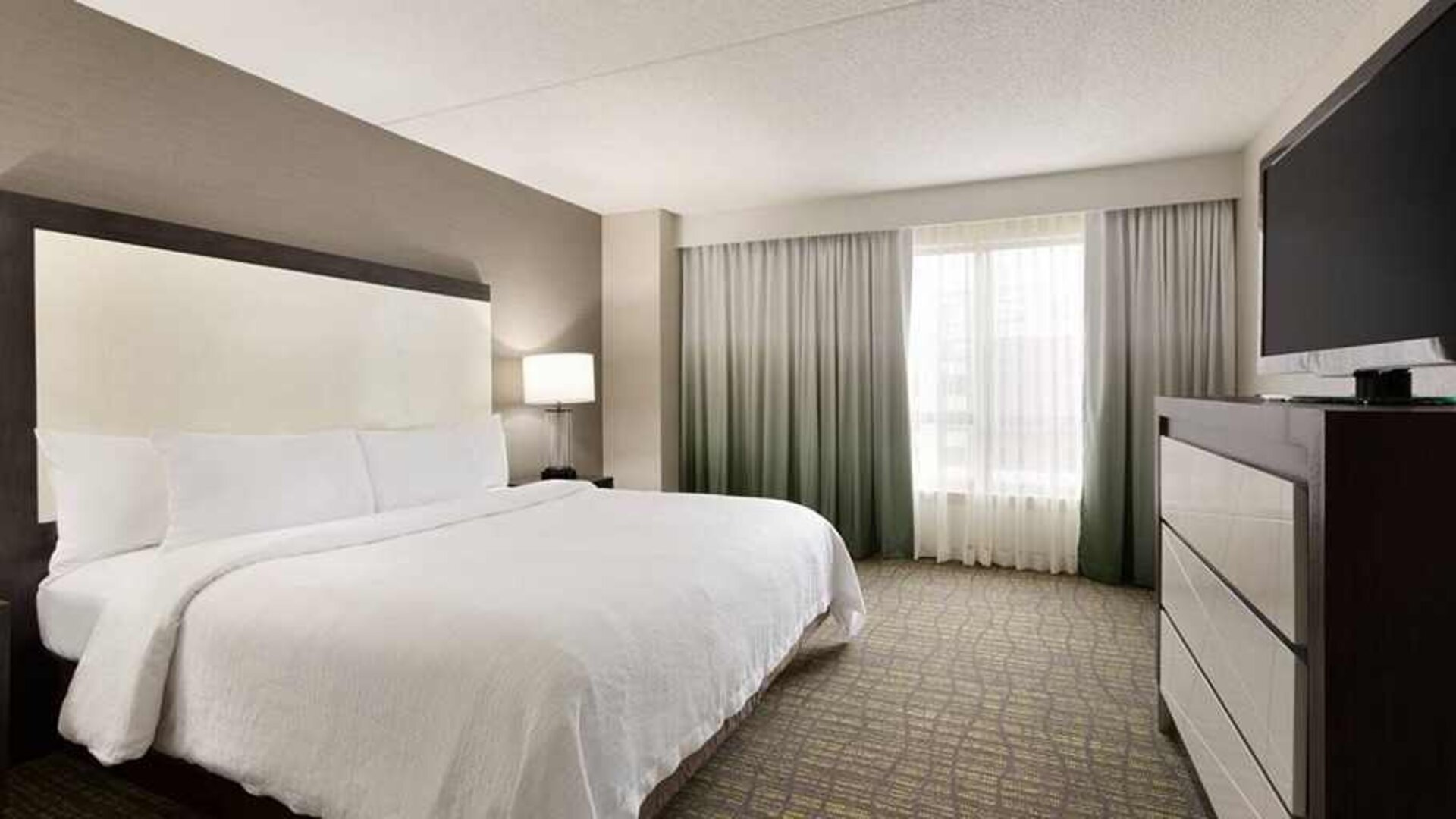 spacious king suite with TV at Embassy Suites by Hilton Newark Wilmington South.