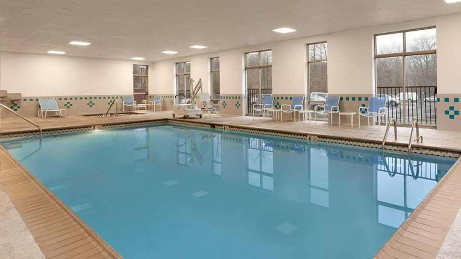 lovely indoor pool with surround seating area at Embassy Suites by Hilton Newark Wilmington South.