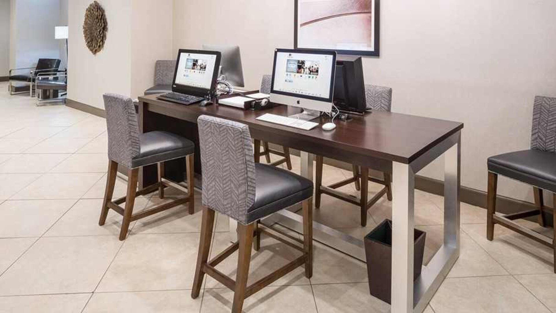 Business center and coworking space equipped with work desk, PC, internet, and printers at DoubleTree by Hilton Hotel Wilmington.