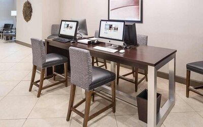 Business center and coworking space equipped with work desk, PC, internet, and printers at DoubleTree by Hilton Hotel Wilmington.