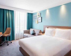 King bedroom with working station at the Hampton by Hilton Belfast City Centre.