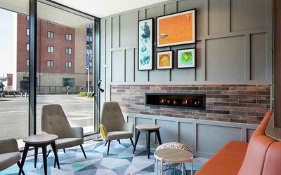 Lobby workspace by the fireplace at the Hampton by Hilton Belfast City Centre.