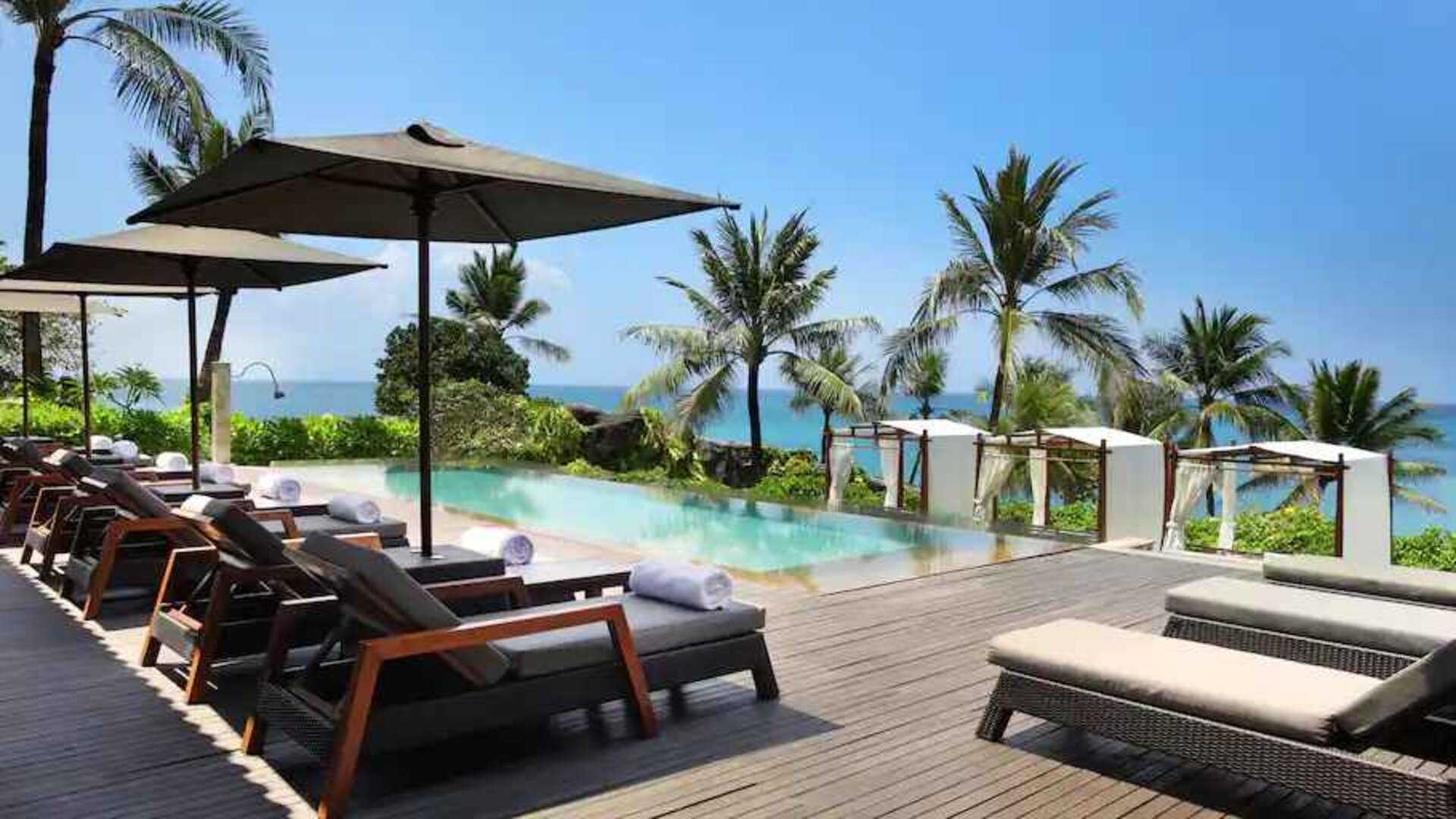 Outdoor pool with lounges at the Hilton Bali Resort.