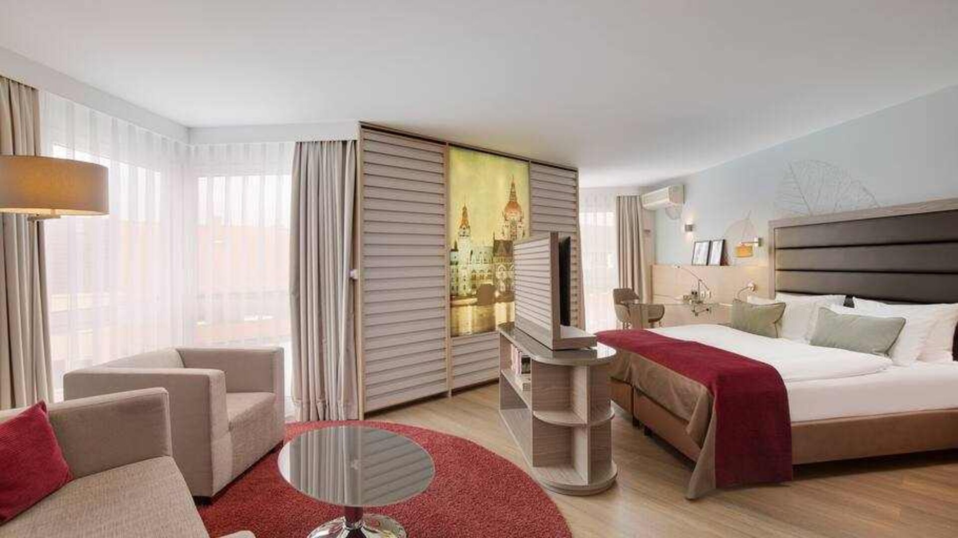 Stylish king suite with working station at the DoubleTree by Hilton Hannover Schweizerhof.