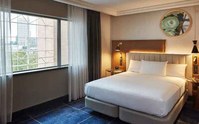 Comfortable hotel room with window at the Hilton Frankfurt City Centre.