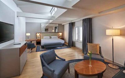 Comfortable king suite with desk at the Hilton Cologne.