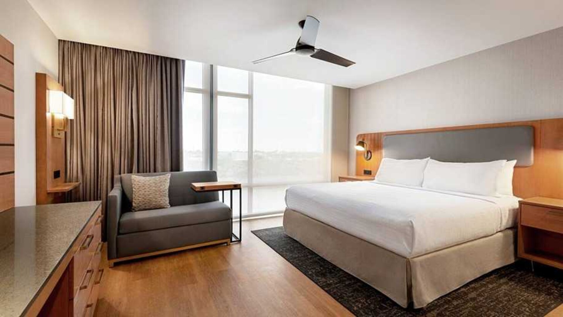 spacious king room with work and lounge area at Homewood Suites by Hilton Wilmington Downtown.