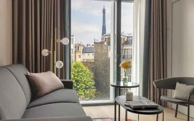 Living room overlooking the tour eiffel at the Canopy by Hilton Paris Trocadero.