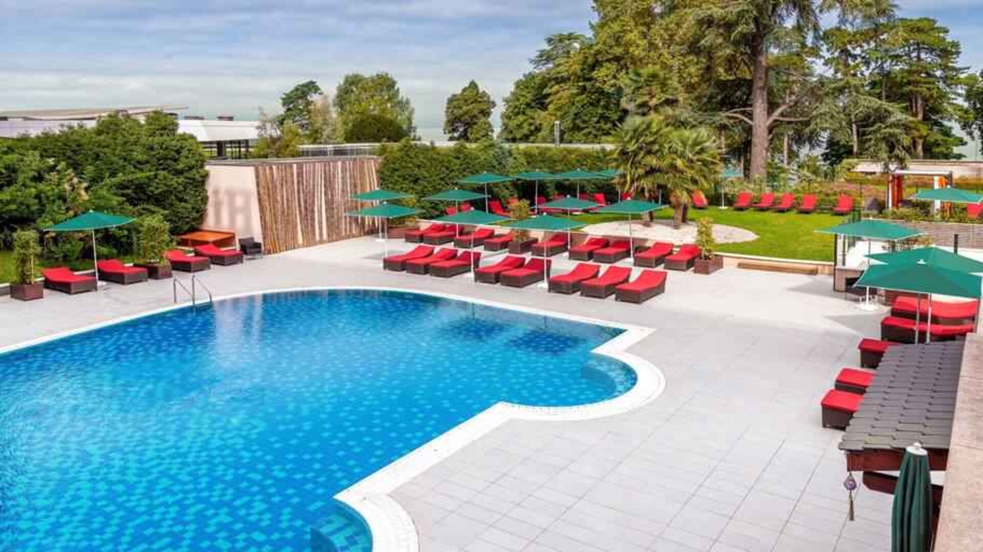 Outdoor pool with lounges at the Hilton Evian-les-Bains.