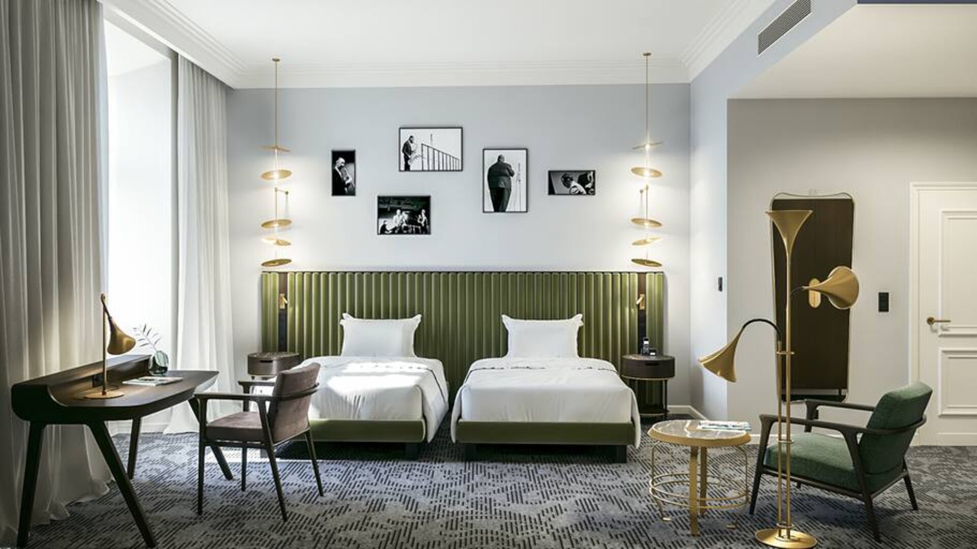 Bright twin room with desk and chairs at the Hotel Saski Krakow Curio Collection by Hilton.